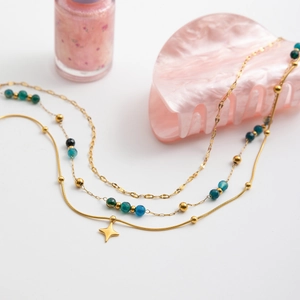 Vue détaillée du collier triple rang en acier doré 18K avec pierres naturelles et étoile