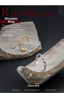 Detailed close-up of gold and silver geometric rhombic rings on stone display