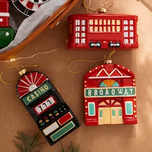 Set of 3 vintage Christmas tree ornaments including trolley, casino, and theater designs