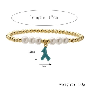 Detail view of 17cm gold bead bracelet with white pearls and a green coral pendant