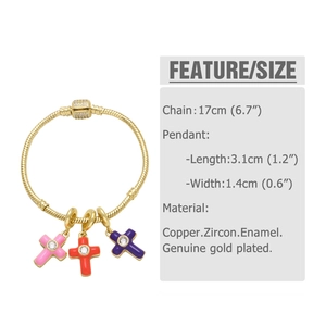 Detail of colorful enamel cross charms with zircons on a gold-plated snake chain bracelet