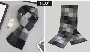 Detailed view of luxury wool blend scarf with classic black and grey plaid and soft fringes