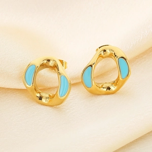 Detail of gold geometric earrings with sky blue enamel on smooth silk background