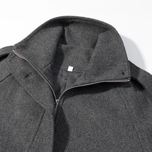 Close-up of high-neck wool coat with silver metal zipper and epaulet shoulder detail