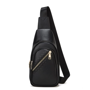 Close-up of black litchi pattern leather sling bag featuring elegant golden metal zippers
