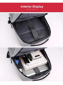 Detail view of the spacious main compartment and padded laptop sleeve of the gray backpack