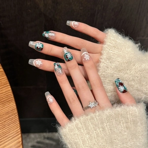 Handmade Christmas press-on nails with winter snowflake art and sparkling glitter finish