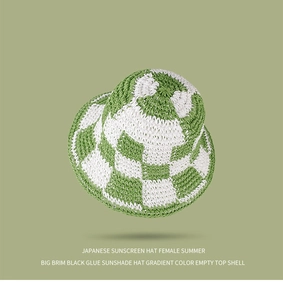 Close-up of green and white checkerboard knit sun hat with detailed woven texture