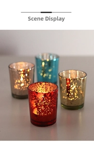 Close-up of starry electroplated glass candle holders in red gold silver and blue