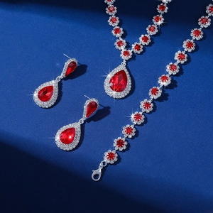 Detailed view of red teardrop rhinestone necklace, bracelet and earrings jewelry set