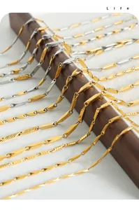 Macro view of bicolor bamboo geometric link chain necklace with detailed Greca engraving