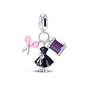 Detailed macro shot of S925 silver sewing charms with enamel dress and scissors