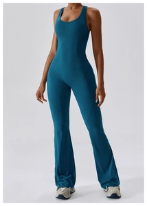 Detail of teal yoga jumpsuit featuring a stylish V-neck and slimming flare pants