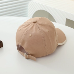 Detail of child baseball cap back showing adjustable metal buckle and cotton fabric texture