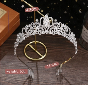 Detail view of silver rhinestone crown with dimensions 4.8cm height and 15.5cm width