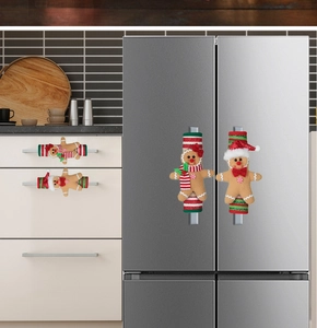 Set of four gingerbread man appliance handle covers on a modern kitchen refrigerator