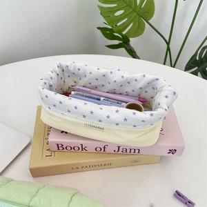 Internal detail of quilted stationery bag featuring blue star lining and spacious storage