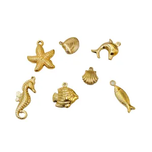 Set of six gold ocean themed charms featuring starfish, dolphin, seahorse and shells