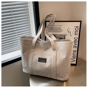Detail of minimalist beige canvas tote bag with textured fabric under natural light