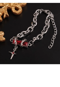 Gothic silver chain necklace with red gemstone and cross pendant close-up view