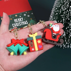 Three-piece PVC Christmas keychain set with Santa, gingerbread box, and festive bell