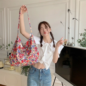 Floral canvas tote bag with large capacity shown in a stylish lifestyle interior scene