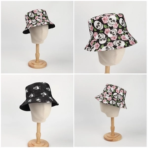 Detail view of double-sided bucket hat featuring skull and pink rose print patterns