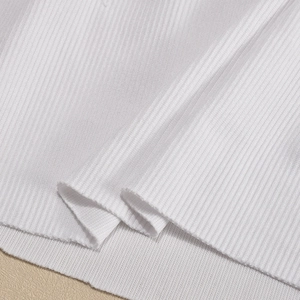 Macro shot of white ribbed knit fabric texture on a slim crop top for women