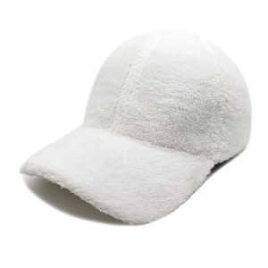 Detailed close-up of the white faux mink fur texture on a soft winter baseball cap