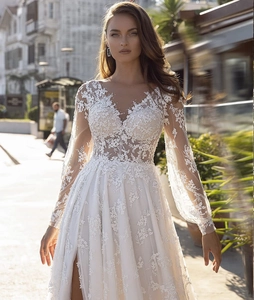 Detailed lace applique on vintage V-neck wedding dress with long sleeves and high slit