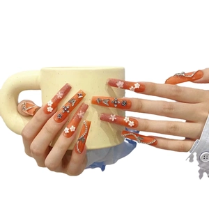 Extra long orange gradient fake nails with 3D metal charms, flowers, and snake chains