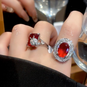 Macro detail of luxury silver rings with rectangle red ruby and micro-paved diamonds