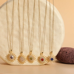 Detailed display of five sunflower zircon pendants in gold plated brass with various gems