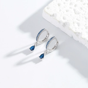 Detailed macro view of S925 silver drop earrings with deep blue zircon and crystals