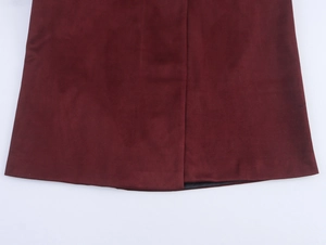 Detailed view of the burgundy faux suede coat hem showing premium fabric texture