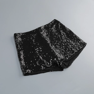 Detail of black sequined shorts featuring silver-black shimmer and elastic waistband