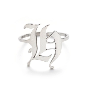 Macro detail of gothic style silver letter H opening ring with vintage metal finish