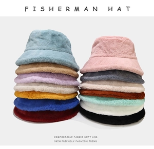 Vertical stack of multi-colored plush fisherman hats showing soft faux fur textures