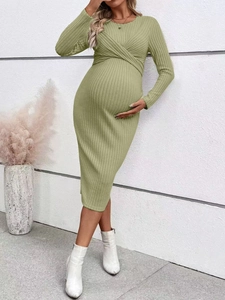 Detail of green long sleeve maternity dress showing twisted knot front and ribbed texture
