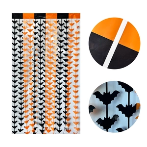 Detail of Halloween tinsel curtain with black and orange bat patterns and adhesive top