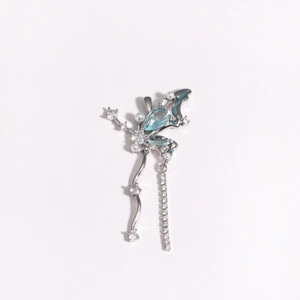 Macro shot of silver butterfly pendant with blue stones, pearls and dangling crystals