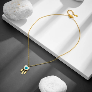 Gold stainless steel necklace featuring evil eye heart pendant and leaf charms on stones
