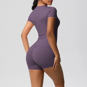 Detail of high-stretch seamless yoga set featuring tight fit shorts and top in dark purple