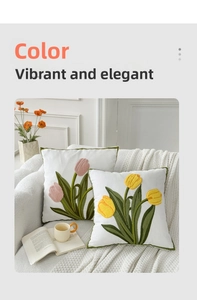 Close-up of tulip flower embroidery with textured towel stitching on soft white pillow covers