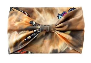 Detailed flat lay of a brown floral elastic wide headband with butterfly print
