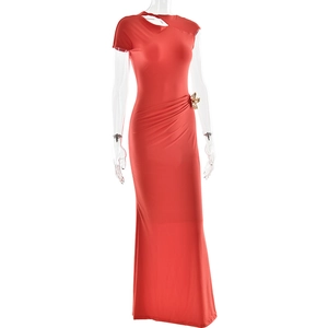 Detail of red slim fit dress with gold flower ornament and elegant waist pleats