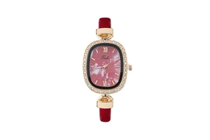 Detail of elegant gold oval watch case with rhinestones and red leather strap