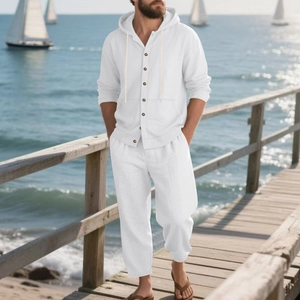 Detail of white linen beach set featuring hooded button shirt and drawstring pants