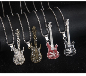 Detailed close-up of guitar pendants with colorful enamel and intricate engraved patterns