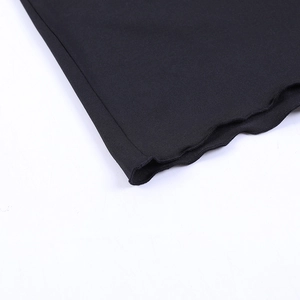Detail of sexy black skirt set showing high-elastic knit fabric and lettuce trim edges